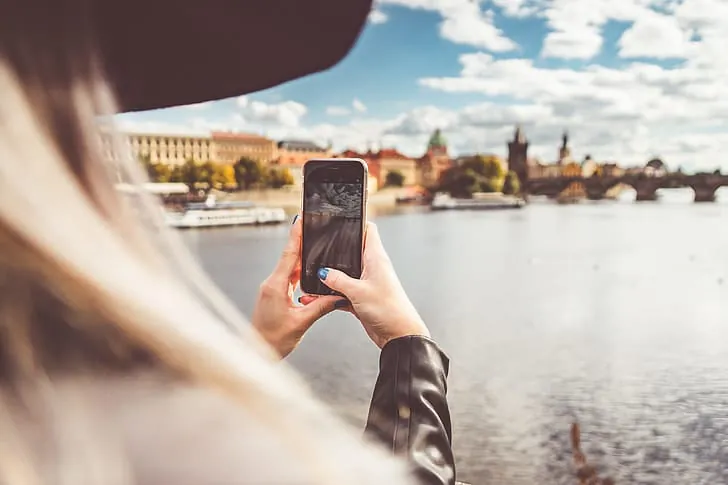 Traveller taking a photo with a smartphone in a city
