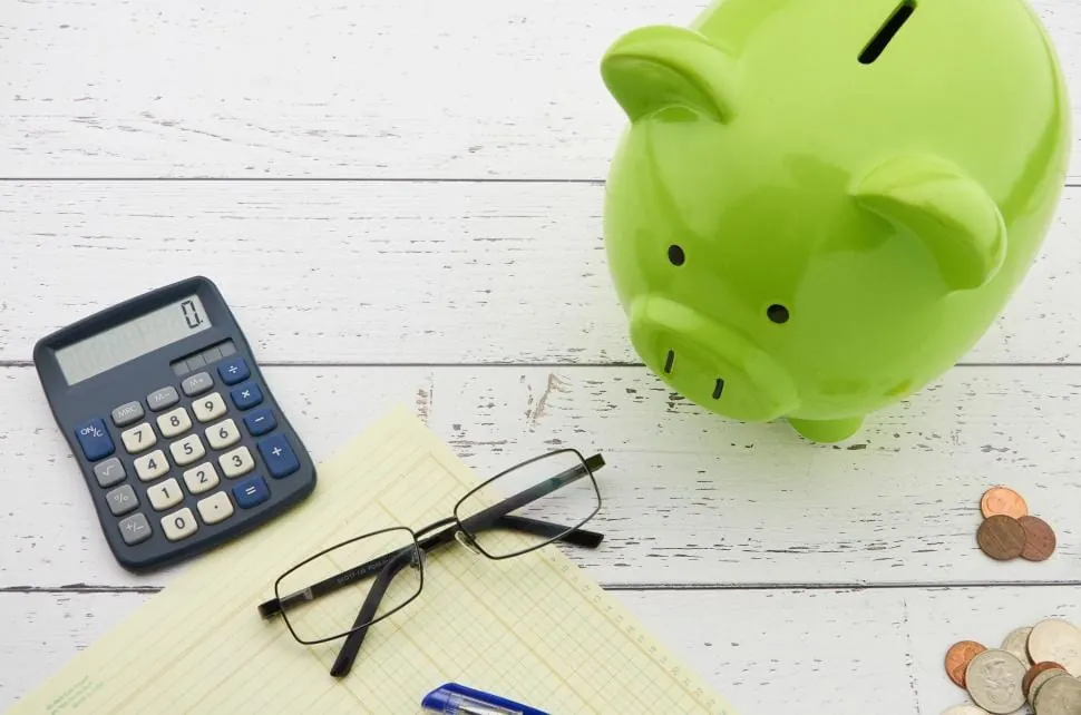 Piggy bank and calculator representing travel budget planning